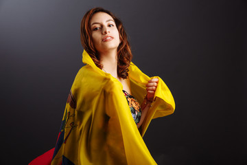 Happy Ecuadorian woman smiling and posing with a flag - isolated over a gray background