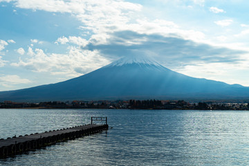 Mountain Fuji in the cloudy day with reflection in the water. Kawaguchiko lake area - Yamanashi, Japan.