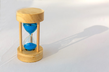 Wood hourglass or sandglass with home. Invertible device with two connected glass bulbs containing...