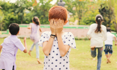 Childrens playing hide and seek at park - Multi ethnic kids playing outdoor games