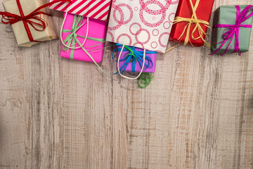 Colorful gift boxes on wooden table top view. Presents, new year and Christmas celebration