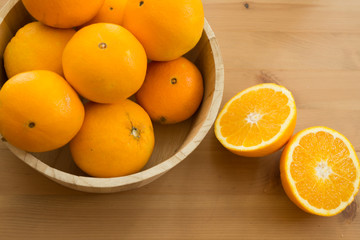 Delicious sweet oranges on wooden background