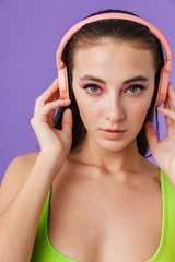Photo of nice fashion woman using headphones and looking at camera