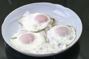 Three fried eggs for healthy breakfast . - 310440086