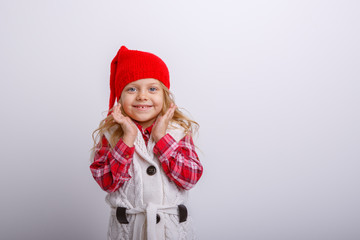 smiling little girl in Santa hat isolated on white background