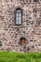 Fototapeta na wymiar Two windows in the stone wall of the Vyborg Castle front view, Vyborg, Leningrad Oblast, Russia