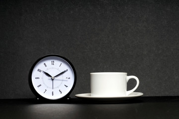 Fototapeta na wymiar Time for a Break. Coffee cup with clock on black background