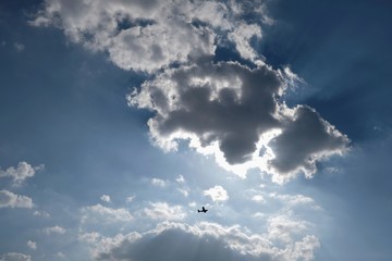 silhouette of a small plane in the blue sky