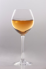 Glass of white wine on a white background and with soft shadow.