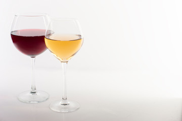 Glass of red and white wine on a white background and with soft shadow.