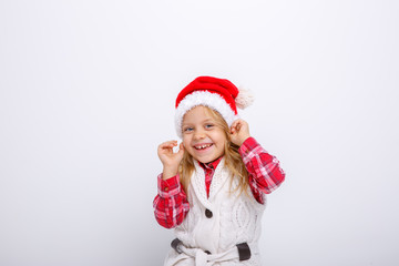 cute happy little girl in santa claus hat. Santa's helper on a white background