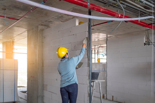 The contractor is installing the wall. Picture of the building under construction with autoclaved aerated concrete.