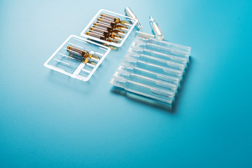 Ampoules with medicine on a blue background