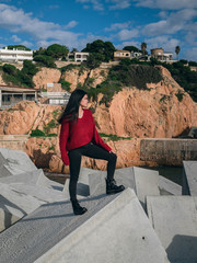 Fototapeta premium woman on rocks in harbor