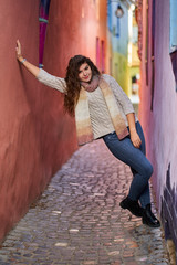 Naklejka premium Young woman on a narrow old street