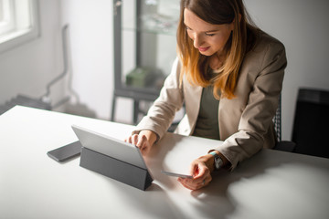 Smiling Woman Paying with Cedit Card Online	