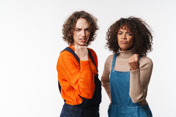 Portrait of angry multinational women showing fists at camera