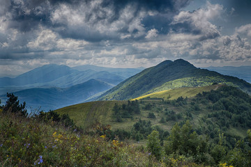Fototapeta na wymiar panorama of the Caucasus mountains. The greater Caucasus mountain range, grass, blue sky, pine