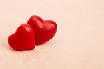 Two red hearts on Pink background