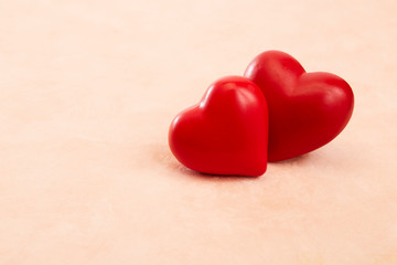 Two red hearts on Pink background