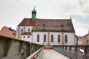 view of St. Oswald Kirche and bridge in Regensburg Germany 