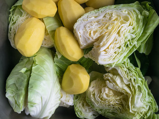 top view of cabbage and raw peeled potatoes