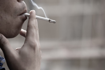 man smoking a cigarette. Cigarette smoke spread.