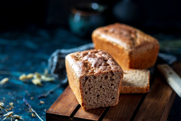 Sourdough bread. Sliced rye bread on a dark background. Healthy eating concept.
