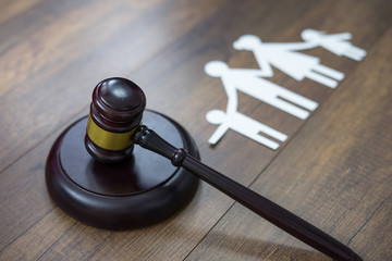 Family figure and gavel on table. Family law concept