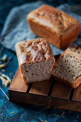Fototapeta na wymiar Sourdough bread. Sliced rye bread on a dark background. Healthy eating concept.