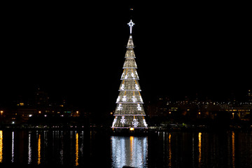 Floating Christmas tree on the city lake of Rio de Janeiro with snowy white light decoration