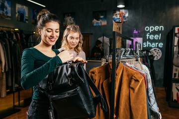 shopping, fashion, style, selling, shopping, business and people. Concept beautiful happy young woman showing class in clothing store. the business owner is a clothing store. business woman