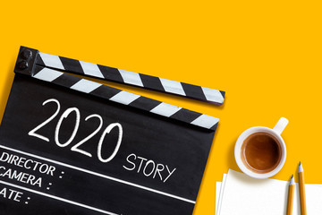 2020 story- text title on film slate.and coffee cup.