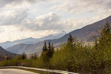 The mountain  road runs between the mountains in Svaneti in the mountainous part of Georgia