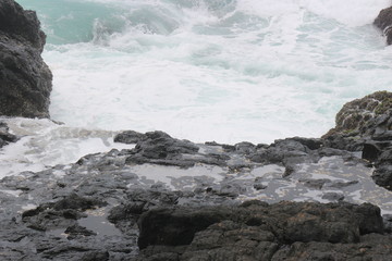 the rocks at the seashore that just hit by the waves