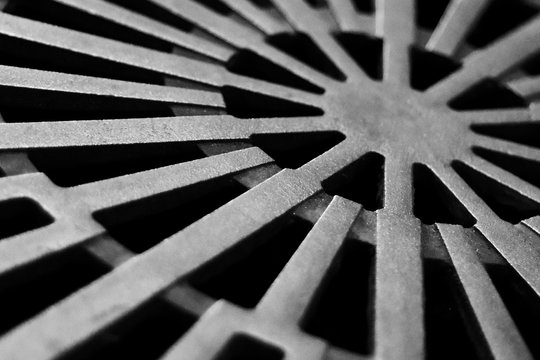 City, old steel textured sewer manhole, metal grunge texture, urban architecture details, background. Steampunk vintage clock bronze element, detail. Abstract hatch cover cast iron design with lines.