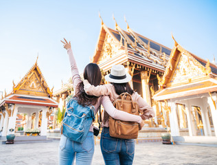 Two happy women traveler at temple in Thailand - obrazy, fototapety, plakaty