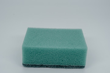 Sponge for washing dishes on a light background close-up
