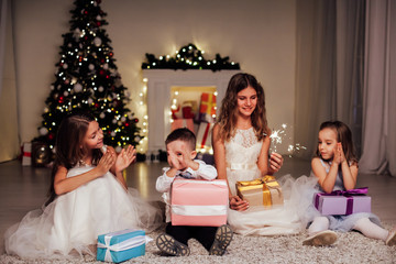 Kids open Christmas sparklers gift new year holiday lights Christmas tree garlands