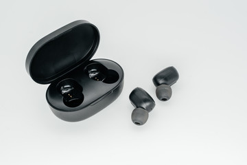 Obraz na płótnie Canvas Bluetooth headphones on a light background close-up