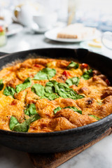 Delicious homemade omelet with vegetables cooked in oven and served in a traditional pan