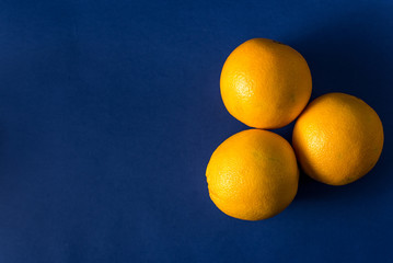 fresh orange on a classic trendy blue background with striped straws
