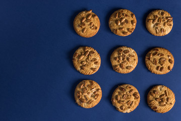  homemade healthy cookies with roasted peanuts on a blue background with place for your text