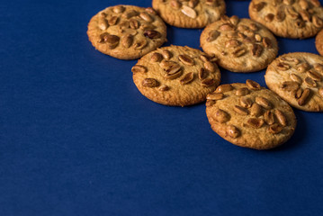  homemade healthy cookies with roasted peanuts on a blue background with place for your text