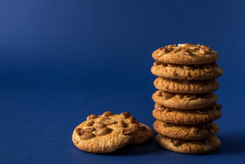 Fototapeta na wymiar homemade healthy cookies with roasted peanuts on a blue background with place for your text