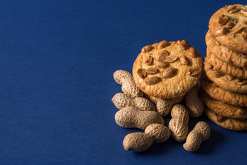  homemade healthy cookies with roasted peanuts on a blue background with place for your text