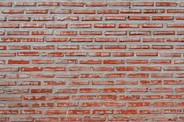 Red brick-block concrete wall in vintage and retro style. Background, wallpaper or texture photo.