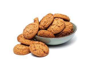 fresh tasty oatmeal cookies in a turquoise plate on a white background