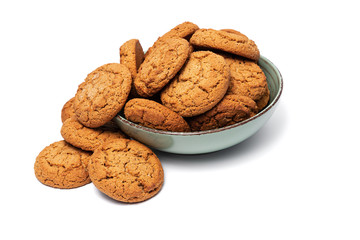 fresh tasty oatmeal cookies in a turquoise plate on a white background