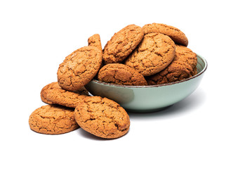 fresh tasty oatmeal cookies in a turquoise plate on a white background